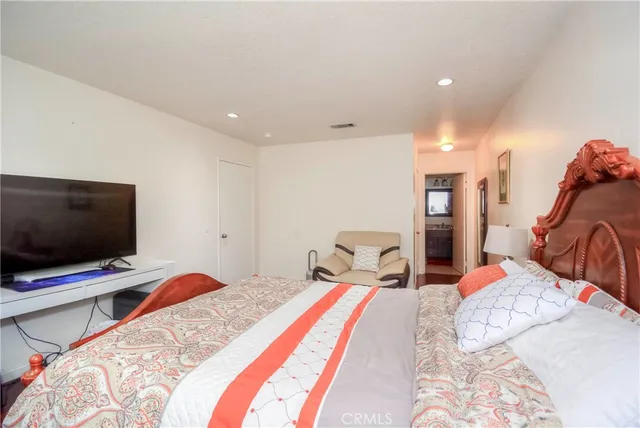 a bedroom with a bed couch and window