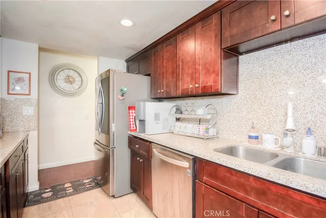 a kitchen with stainless steel appliances granite countertop a refrigerator and a stove top oven