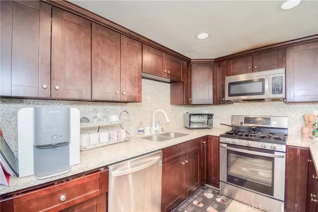 a kitchen with a sink a stove and cabinets