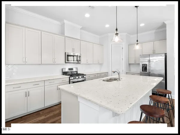 a open kitchen with a sink stove and dining room view