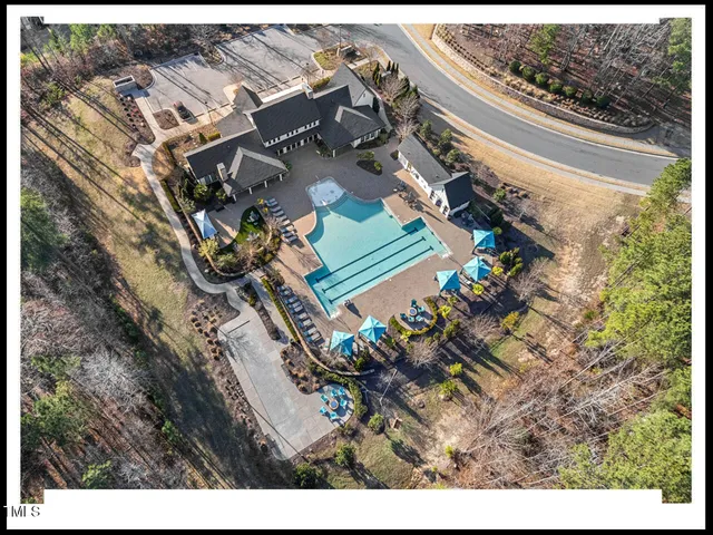 a view of a swimming pool with a yard