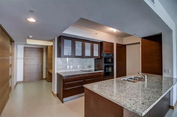 a kitchen with stainless steel appliances granite countertop a sink and cabinets