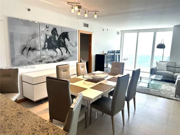 a dining room with furniture and window