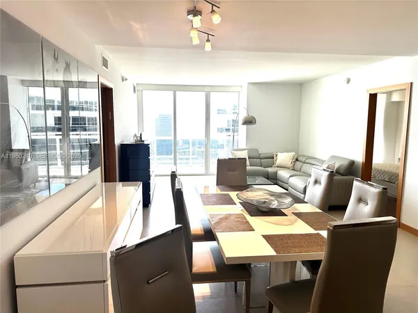 a living room with furniture and large windows