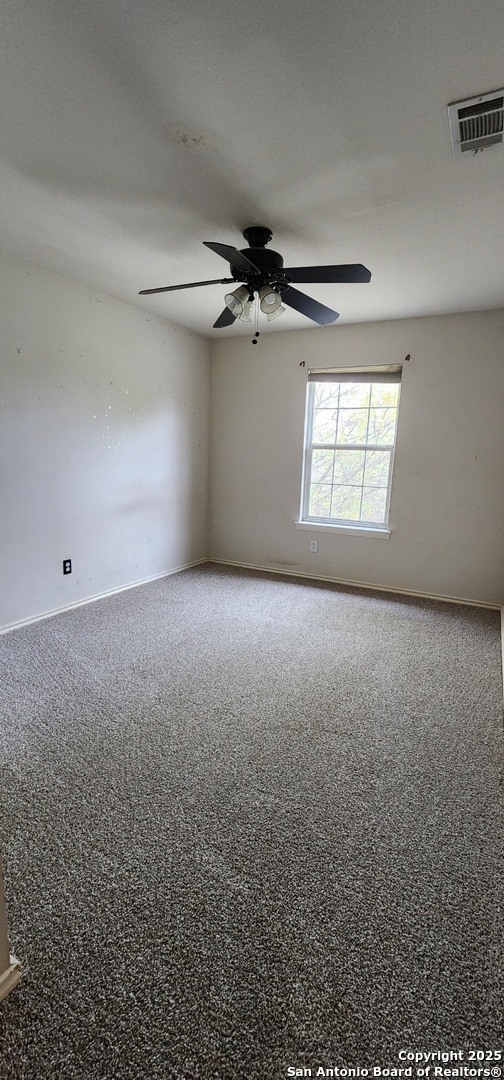 9318 Grand Cedar Helotes, TX 78023 - Photo 20 of 32 an empty room with windows and ceiling fan