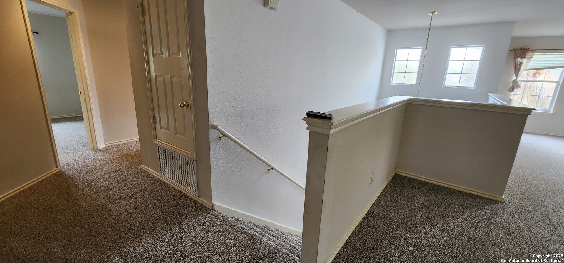9318 Grand Cedar Helotes, TX 78023 - Photo 23 of 32 a view of hallway with windows and stairs