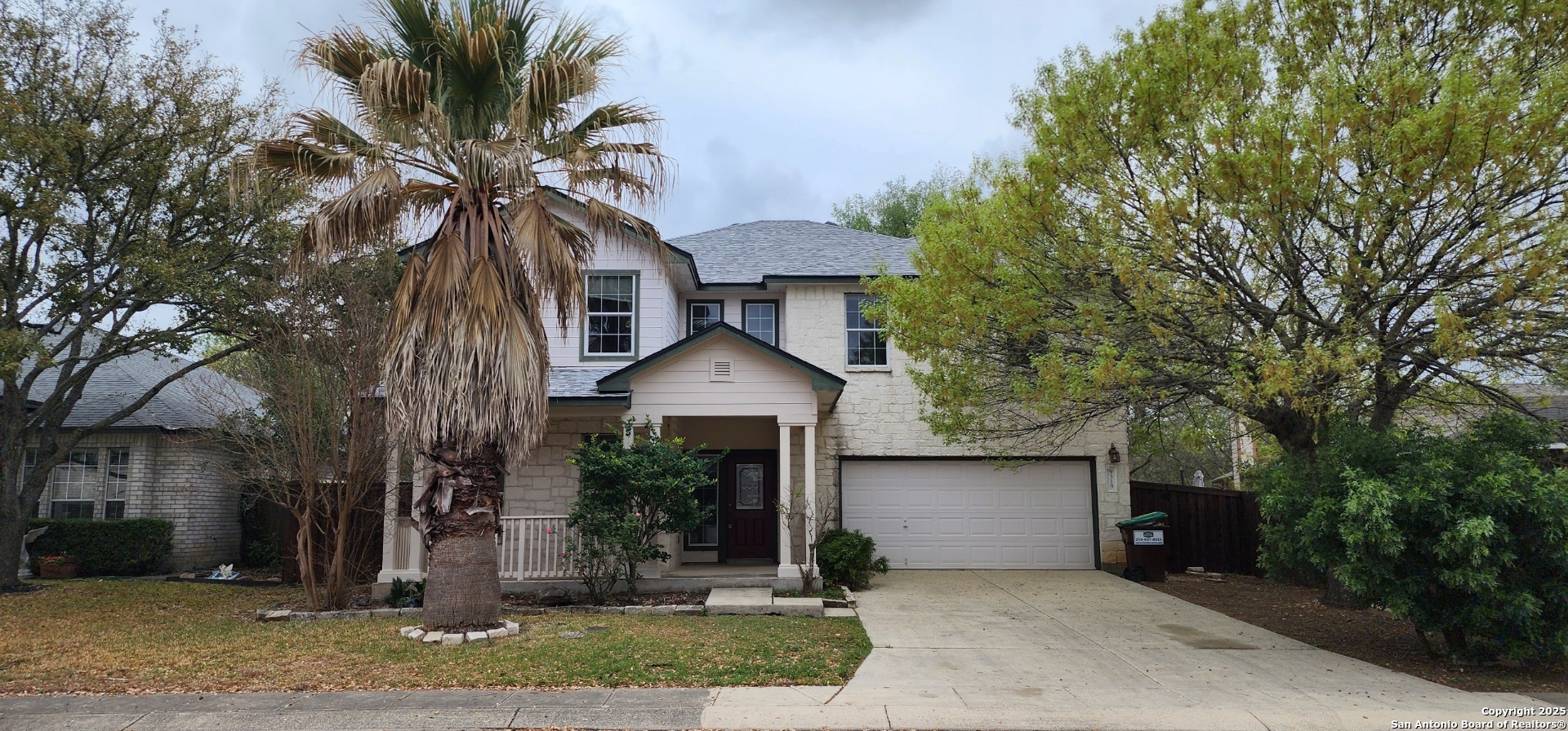 9318 Grand Cedar Helotes, TX 78023 - Photo 6 of 32 a front view of a house with a yard and garage