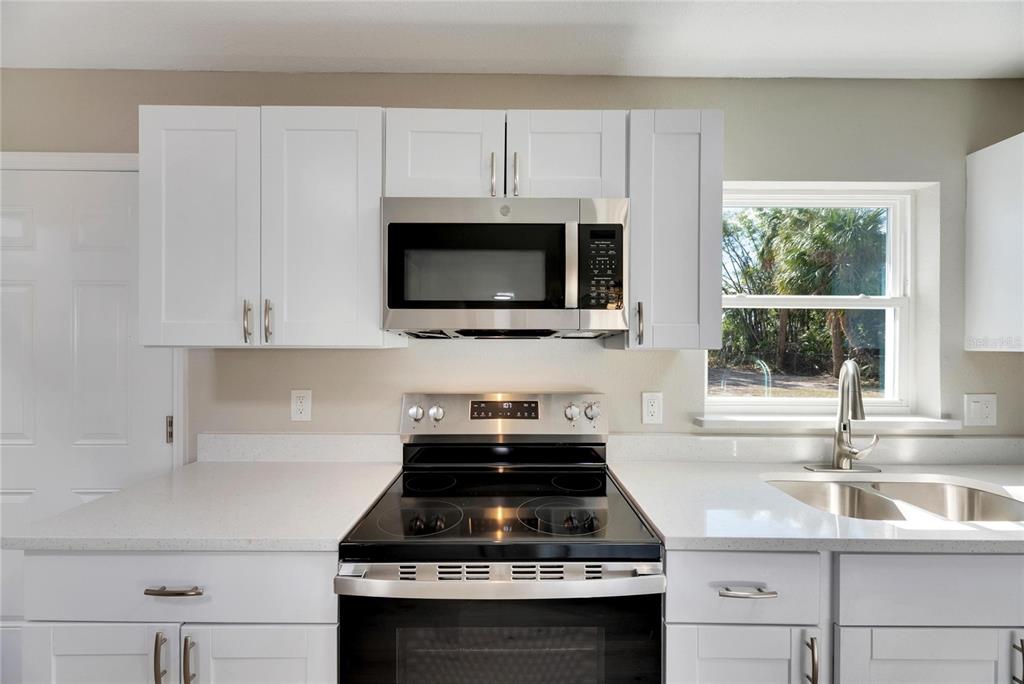660 Flamingo Drive Apollo Beach, FL 33572 - Photo 21 of 63 a kitchen with granite countertop a sink stove top oven and cabinets