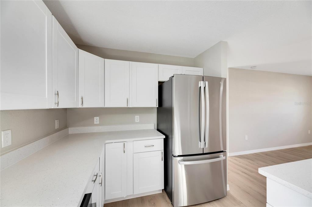 660 Flamingo Drive Apollo Beach, FL 33572 - Photo 22 of 63 a kitchen with a refrigerator sink and cabinets