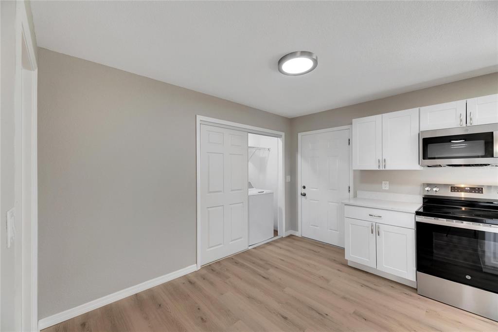 660 Flamingo Drive Apollo Beach, FL 33572 - Photo 23 of 63 a view of a kitchen with wooden floor and electronic appliances