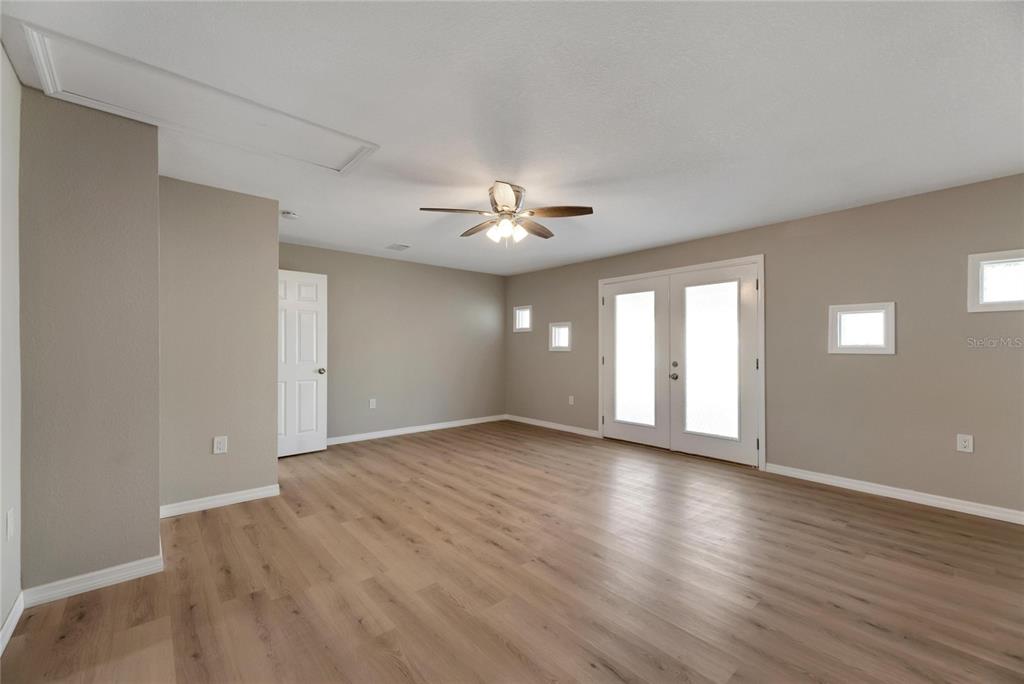 660 Flamingo Drive Apollo Beach, FL 33572 - Photo 27 of 63 a view of an empty room with wooden floor and a window