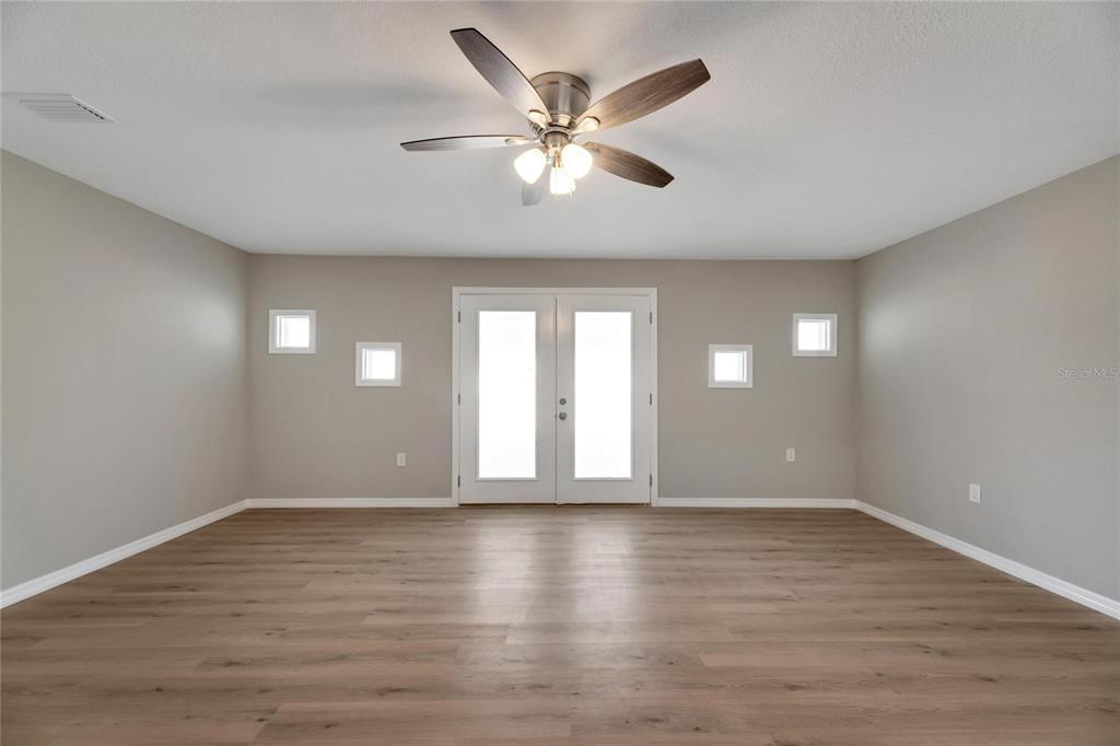 660 Flamingo Drive Apollo Beach, FL 33572 - Photo 28 of 63 a view of an empty room with wooden floor and a window