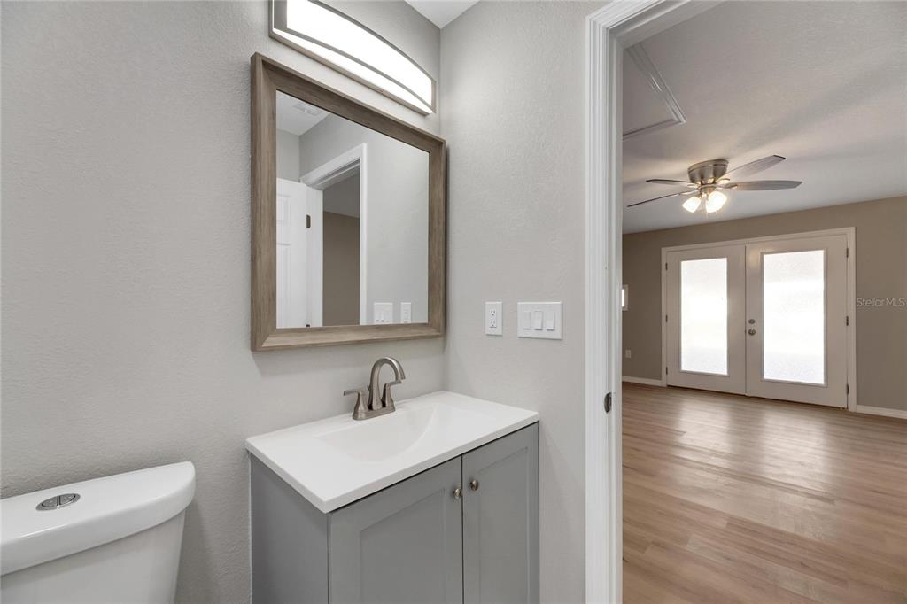 660 Flamingo Drive Apollo Beach, FL 33572 - Photo 30 of 63 a bathroom with a sink a toilet and a mirror