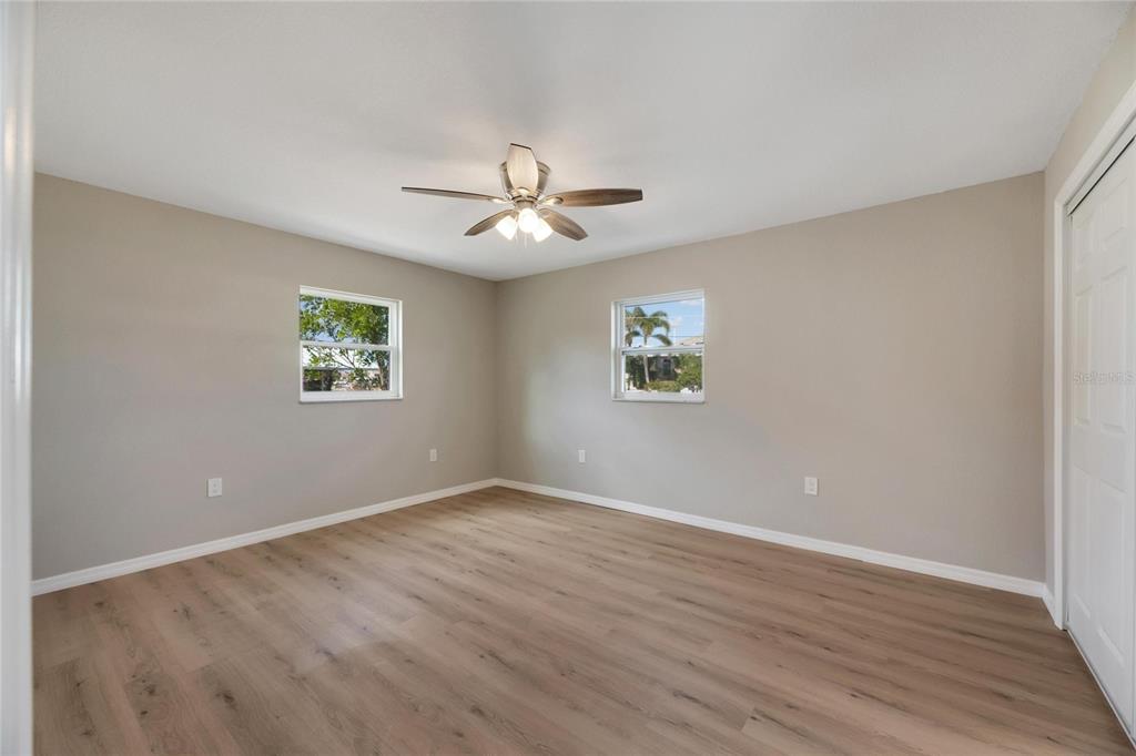 660 Flamingo Drive Apollo Beach, FL 33572 - Photo 33 of 63 a view of an empty room with a window and wooden floor