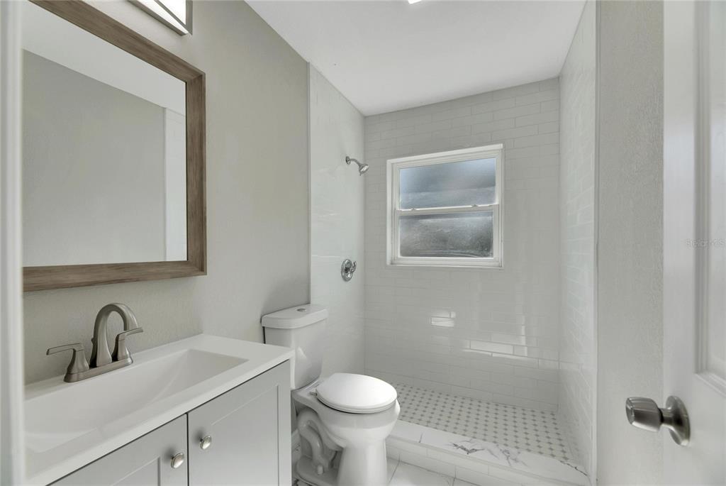 660 Flamingo Drive Apollo Beach, FL 33572 - Photo 36 of 63 a bathroom with a toilet sink and mirror