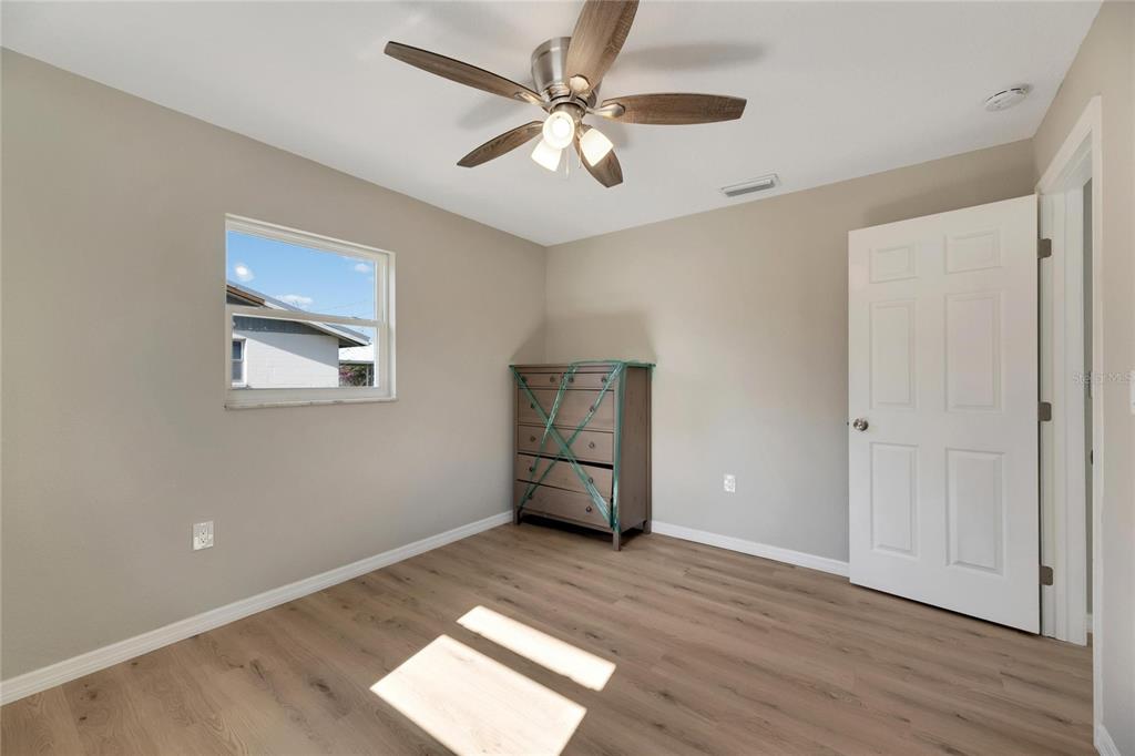 660 Flamingo Drive Apollo Beach, FL 33572 - Photo 39 of 63 a view of empty room with wooden floor and ceiling fan