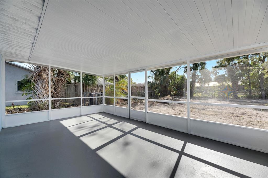 660 Flamingo Drive Apollo Beach, FL 33572 - Photo 4 of 63 a view of an empty room with wooden floor and a window