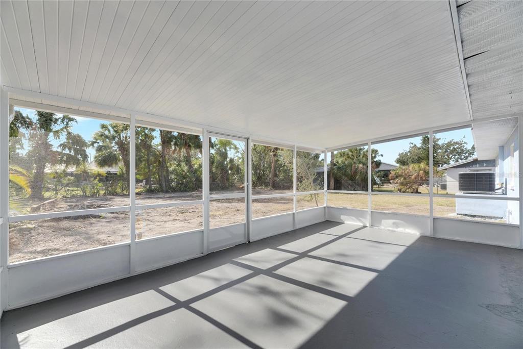 660 Flamingo Drive Apollo Beach, FL 33572 - Photo 41 of 63 a view of an empty room with wooden floor and a large window