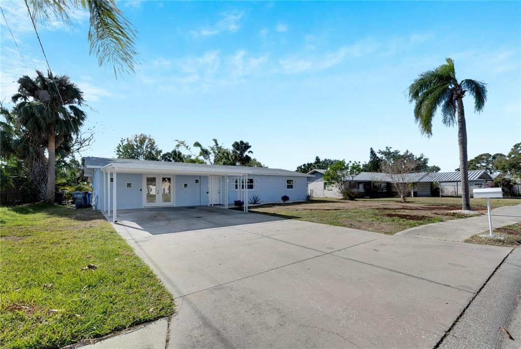 660 Flamingo Drive Apollo Beach, FL 33572 - Photo 5 of 63 a front view of house with yard and trees around