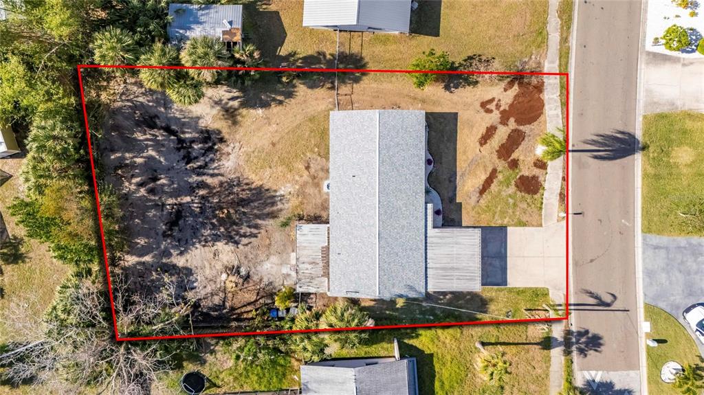 660 Flamingo Drive Apollo Beach, FL 33572 - Photo 52 of 63 aerial view of a house with a yard and large trees