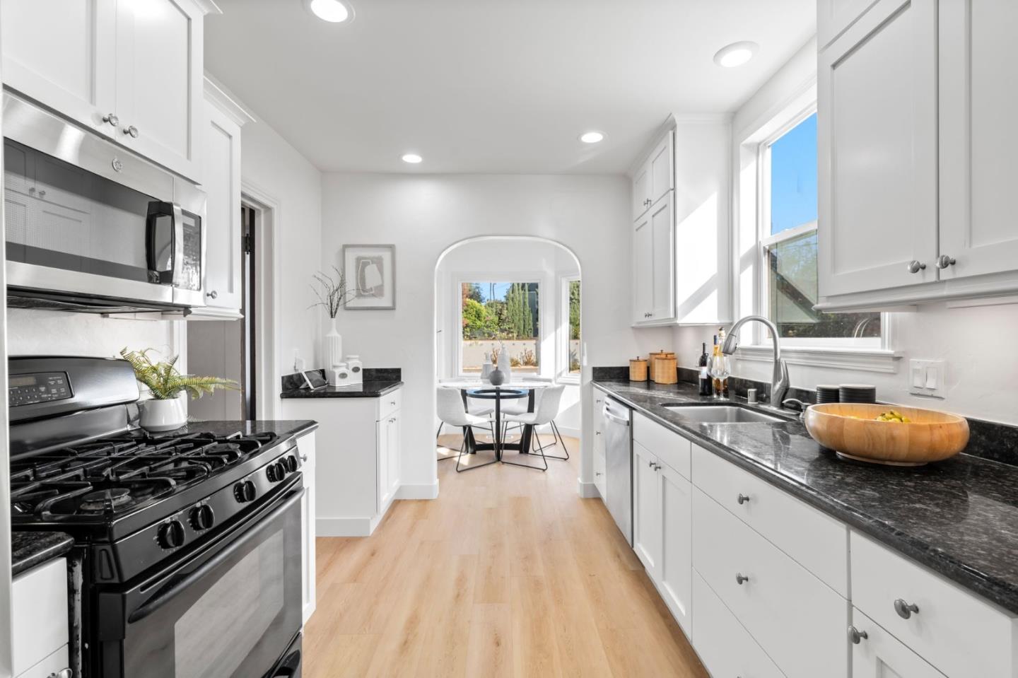 975 Riverside Drive San Jose, CA 95125 - Photo 13 of 46 a kitchen with stainless steel appliances a stove sink microwave and cabinets