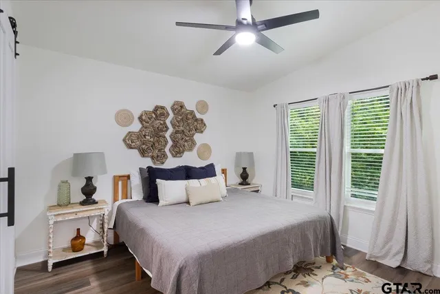 a bedroom with a large bed and a chandelier