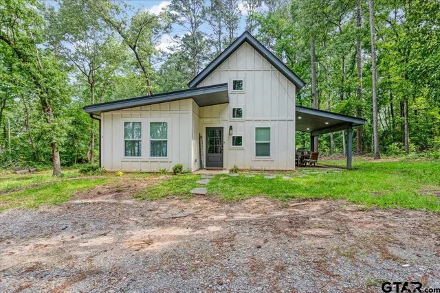 a view of a house with yard and tree s