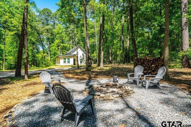 a view of backyard with a table and chairs