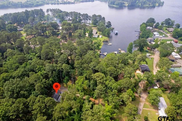an aerial view of a house with a yard and garden