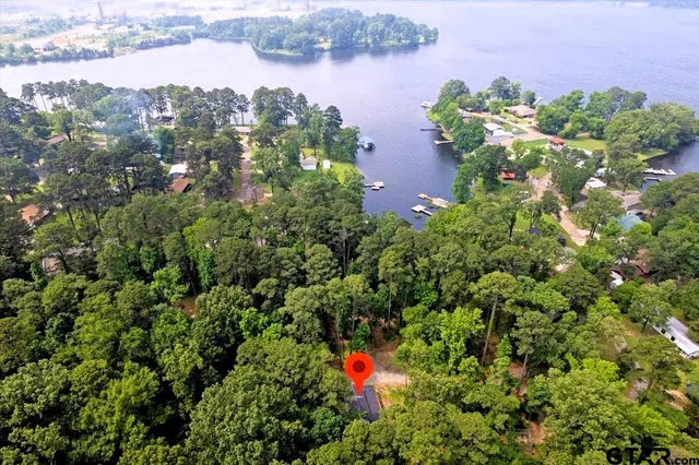an aerial view of a houses with outdoor space and lake view