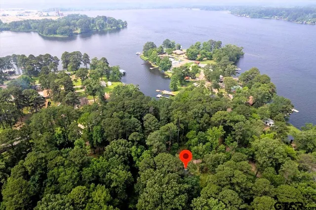 an aerial view of a house with a lake view