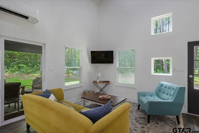 a living room with furniture tv and a window