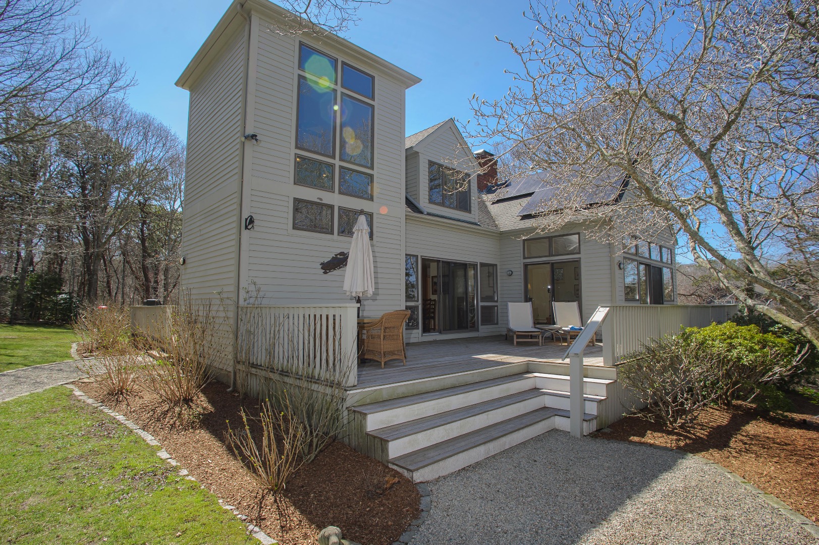 237 Lagoon Pond Road Vineyard Haven, MA 02568 - Photo 2 of 21 a front view of a house with a garden