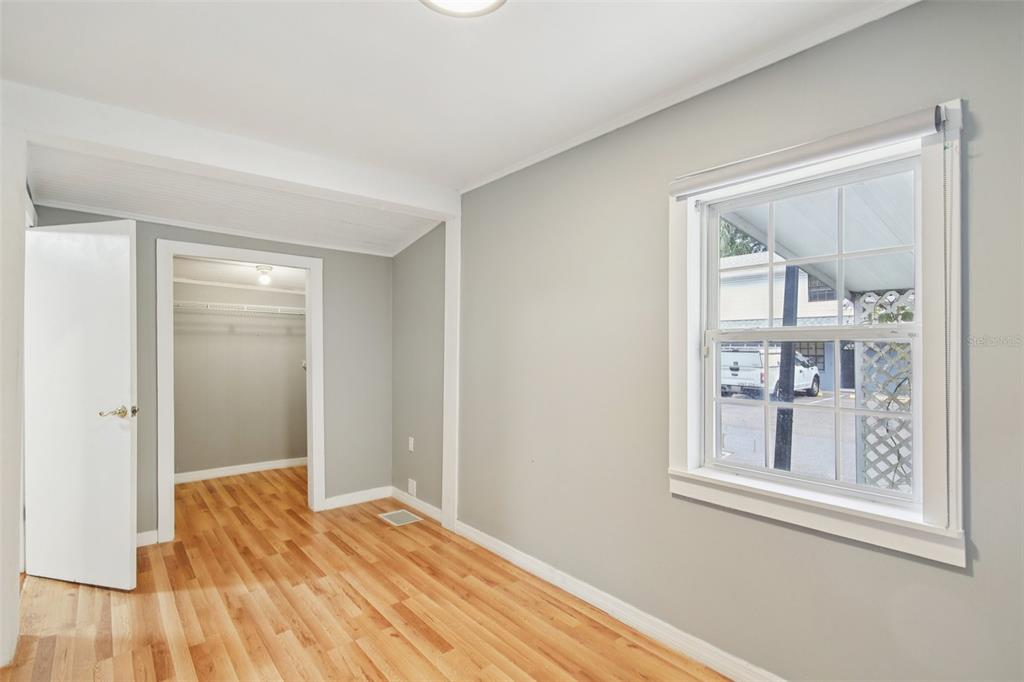 924 Vistabula Street Lakeland, FL 33801 - Photo 12 of 53 a view of a bedroom with wooden floor and windows