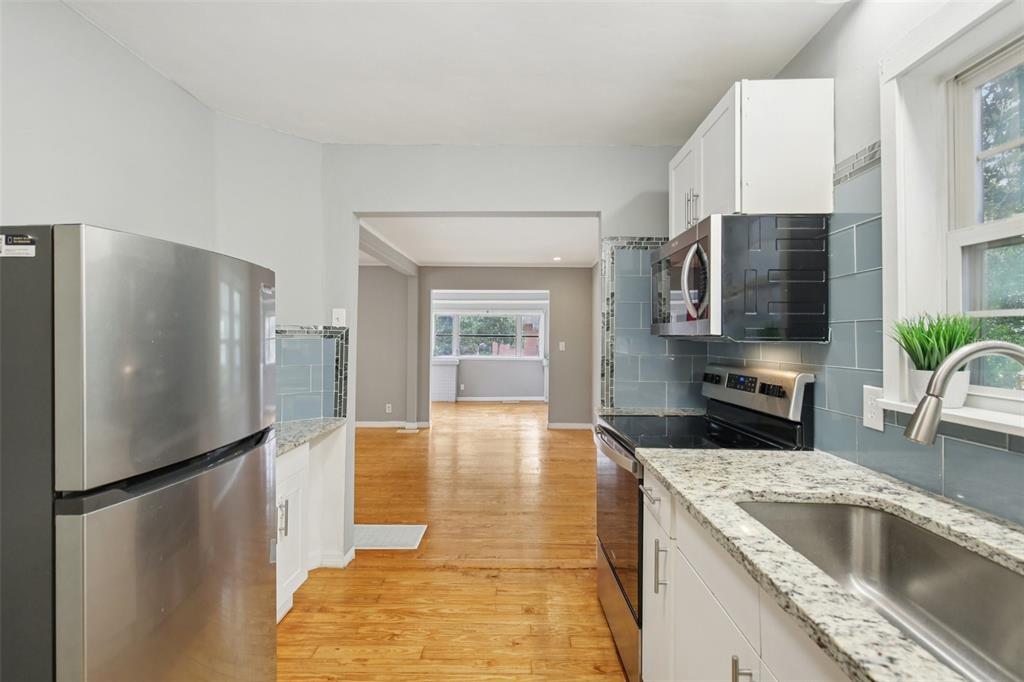 924 Vistabula Street Lakeland, FL 33801 - Photo 19 of 53 a kitchen with granite countertop a refrigerator and a sink