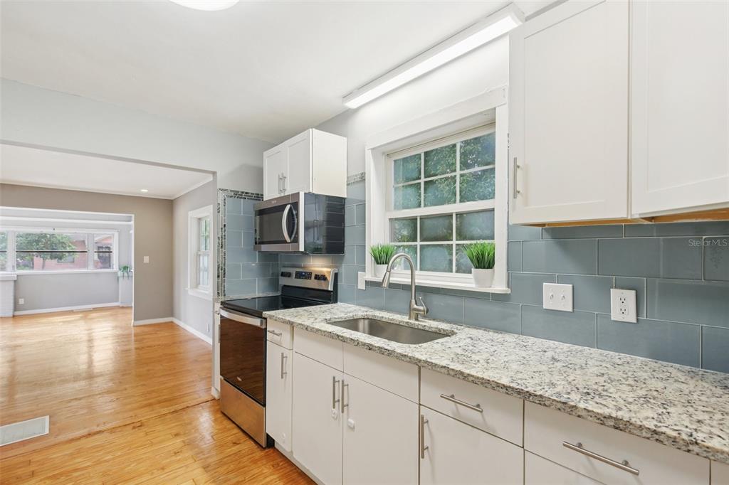 924 Vistabula Street Lakeland, FL 33801 - Photo 20 of 53 a kitchen with granite countertop a sink and a stove