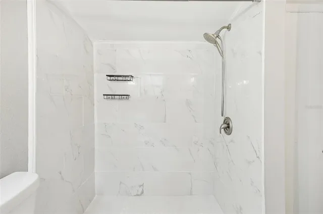 a white toilet sitting next to a bathroom sink