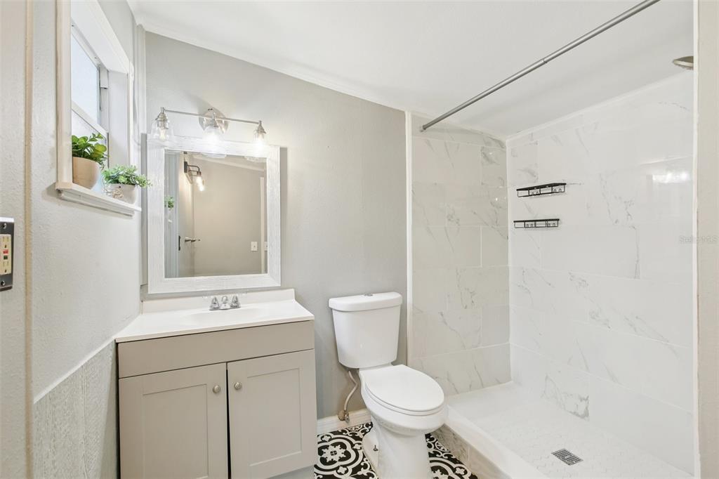 924 Vistabula Street Lakeland, FL 33801 - Photo 28 of 53 a bathroom with a sink toilet a mirror and shower