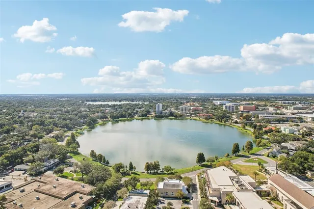 an aerial view of ocean and residential houses with outdoor space