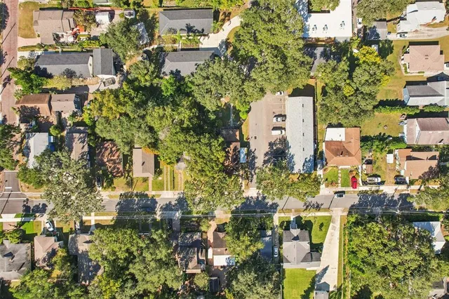 an aerial view of residential building with yard