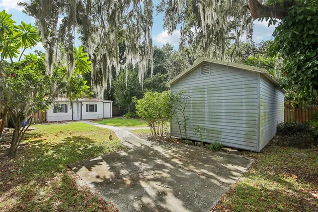 a backyard of a house with table and chairs