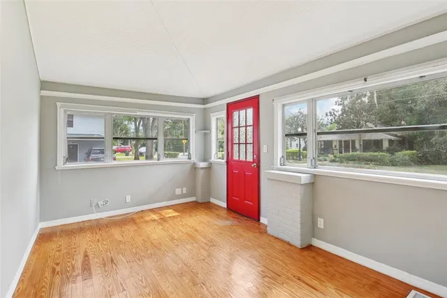 wooden floor in an empty room with a window