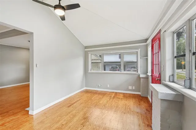 a view of a room with wooden floor and bathroom