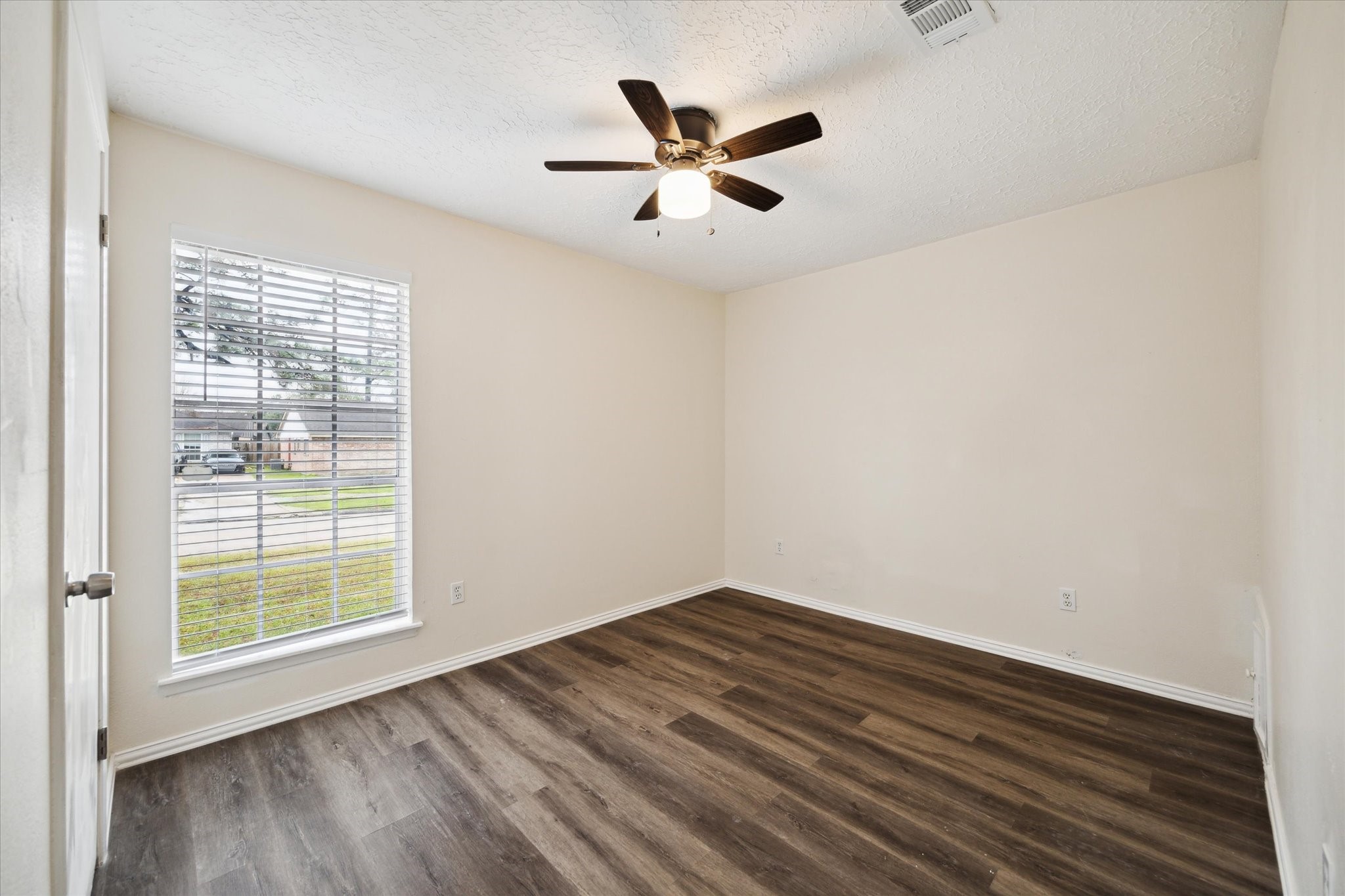5815 Bridgegate Drive Spring, TX 77373 - Photo 13 of 17 a view of empty room with wooden floor and fan