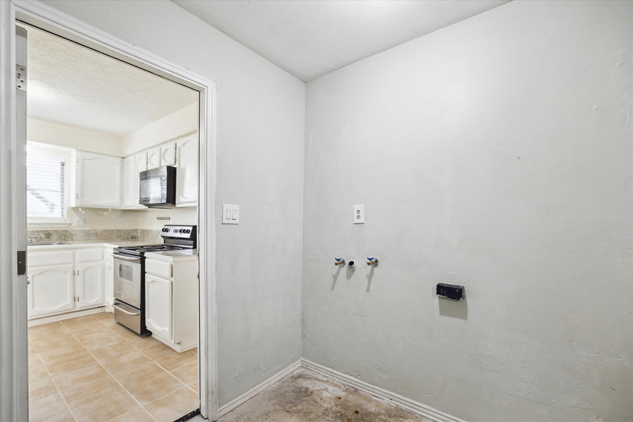 5815 Bridgegate Drive Spring, TX 77373 - Photo 16 of 17 a bathroom with a granite countertop sink and white cabinets
