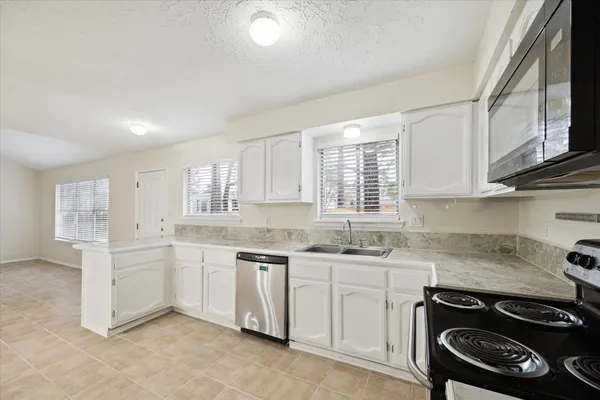 a kitchen that has a sink and a stove