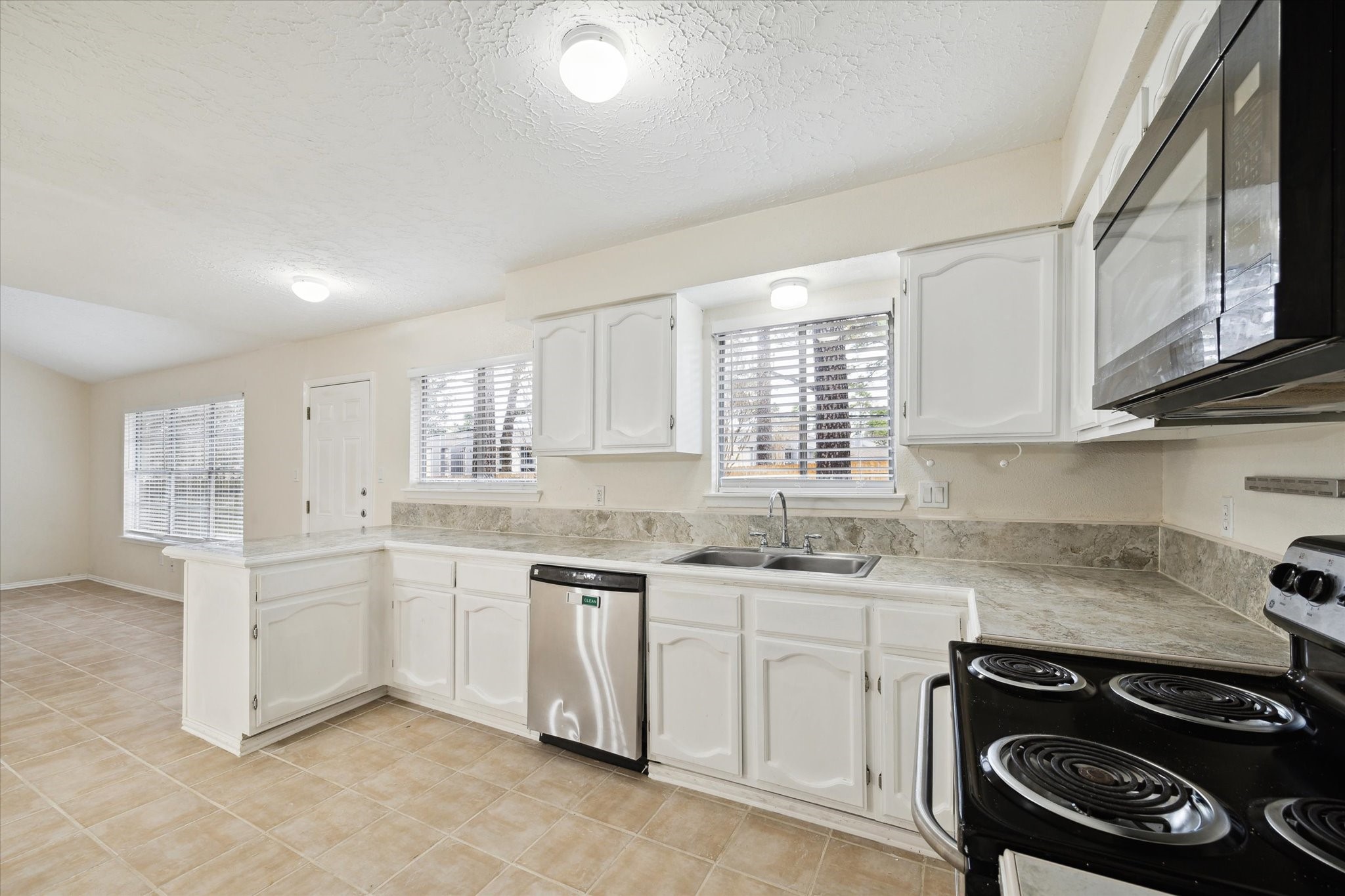 5815 Bridgegate Drive Spring, TX 77373 - Photo 6 of 17 a kitchen that has a sink and a stove
