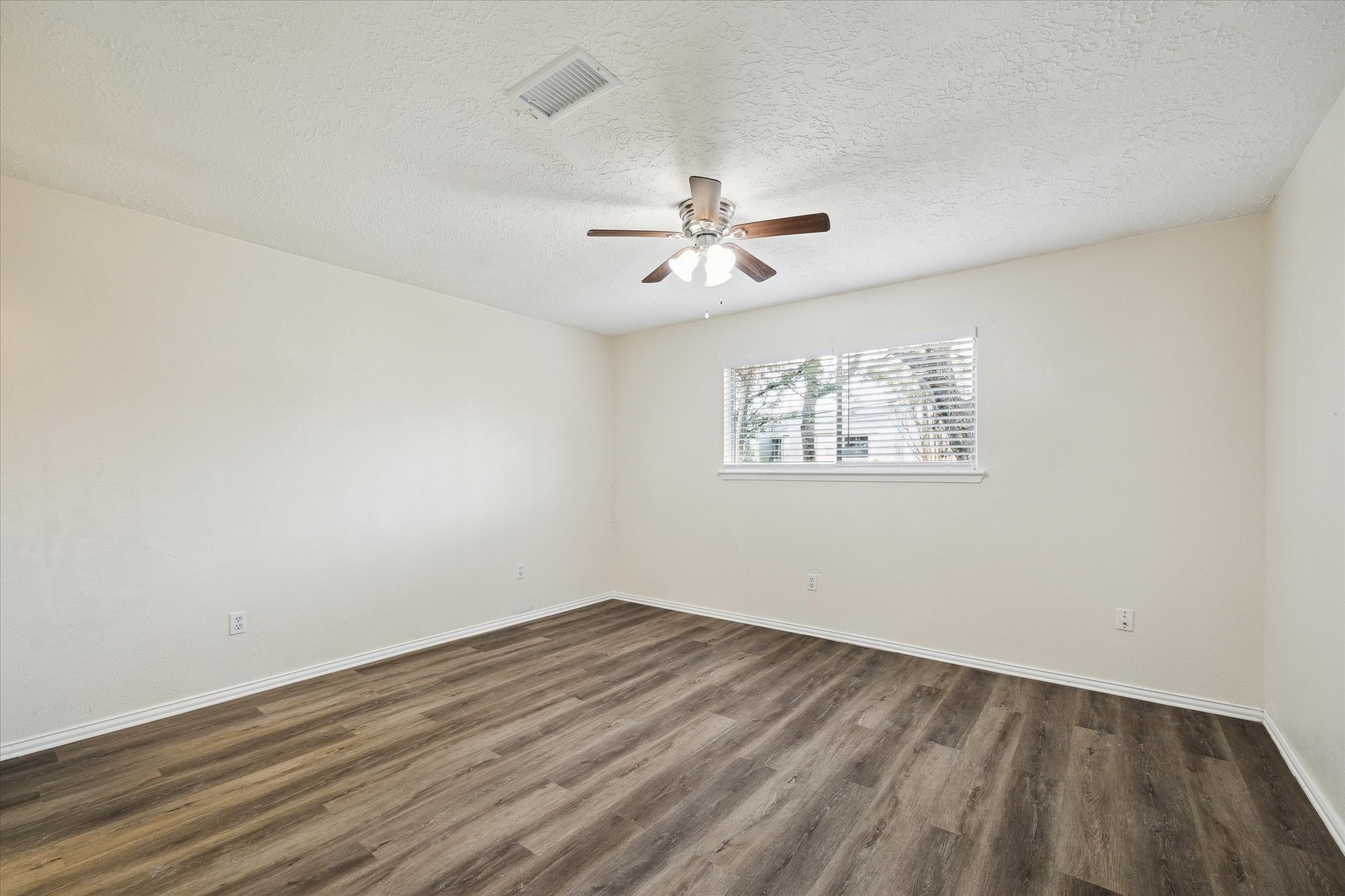 5815 Bridgegate Drive Spring, TX 77373 - Photo 8 of 17 wooden floor in an empty room with a window