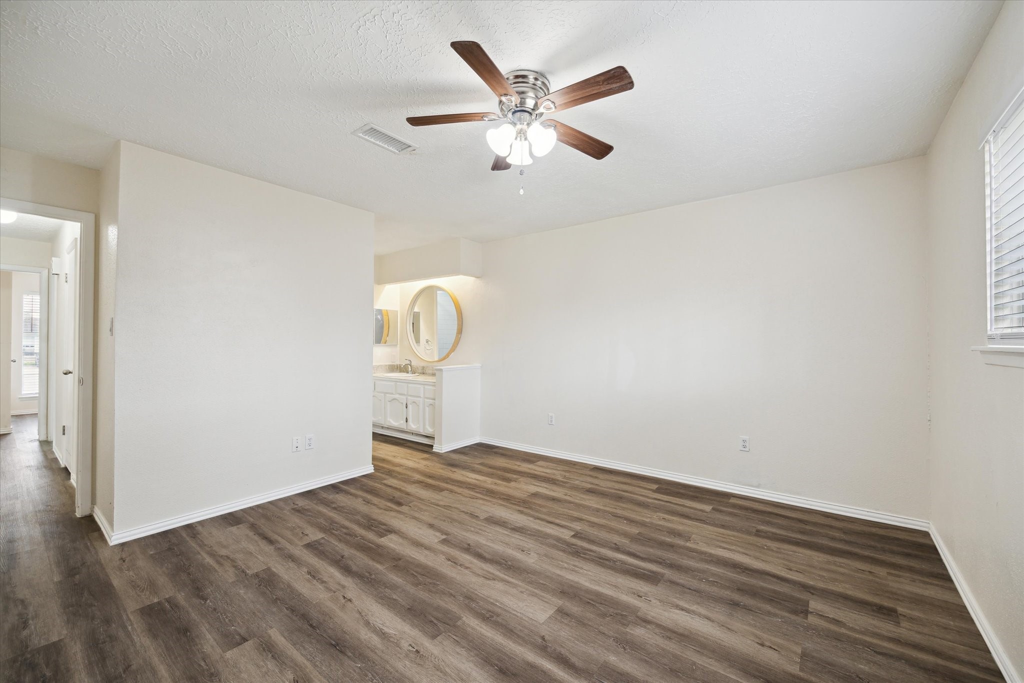 5815 Bridgegate Drive Spring, TX 77373 - Photo 9 of 17 a view of an empty room with wooden floor and a ceiling fan