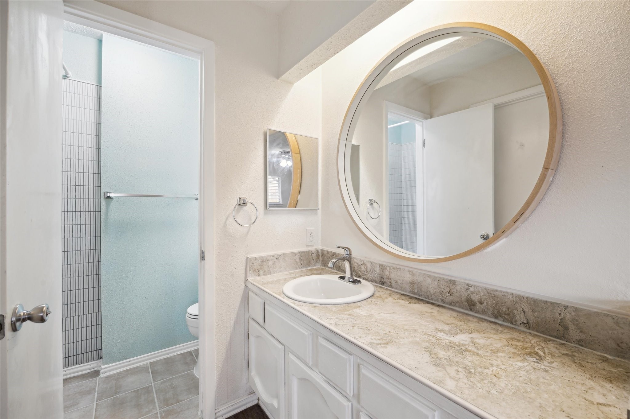 5815 Bridgegate Drive Spring, TX 77373 - Photo 10 of 17 a bathroom with a granite countertop sink a mirror and shower